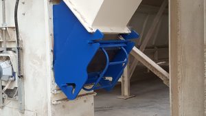 Animal feed transfer chute with integral magnet